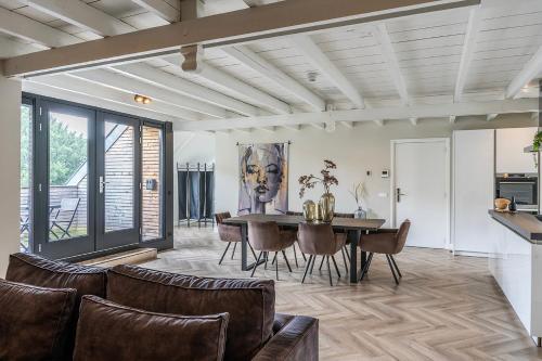 an open living room with a table and chairs at XXL Loft City center Villa Tilburg Willem 2 in Tilburg