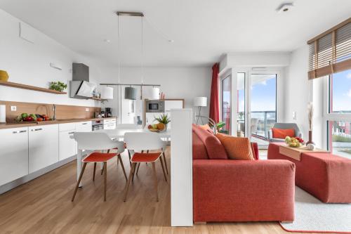 a kitchen and living room with a table and chairs at Ferienwohnung Meermarie Olpenitz in Olpenitz