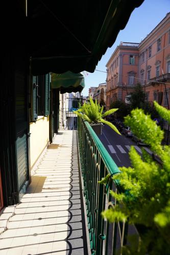 a street with a green fence and some buildings at La Maison di Donna Elena in Cercola