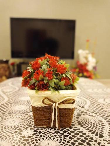 a flower arrangement in a basket on a table at Ipoh Buntong Corner homestay in Ipoh