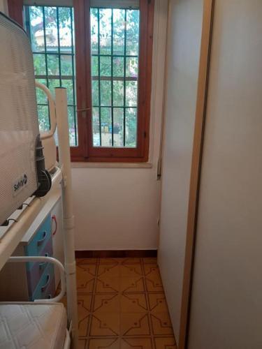 a room with a hallway with a window and a staircase at trilocale sul mare con giardino privato in Sorso