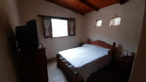 a bedroom with a bed and a flat screen tv at Sol de Maimará in Maimará