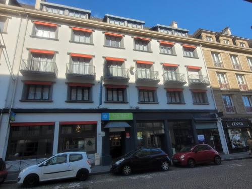 a white building with cars parked in front of it at Sure Hotel By Best Western Lorient Centre in Lorient
