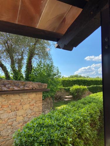 a view from the outside of a house with a stone wall at CasaLeTolfe Residence in Siena
