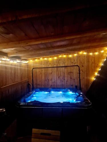a jacuzzi tub with lights in a room at Bucovina-A-FrameHouse-HotTub-Fireplace-Patio-WiFi in Suceviţa