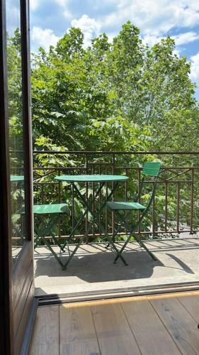 a table and two chairs sitting on a balcony at T2 cocon avec balcon et parking in La Roche-sur-Foron