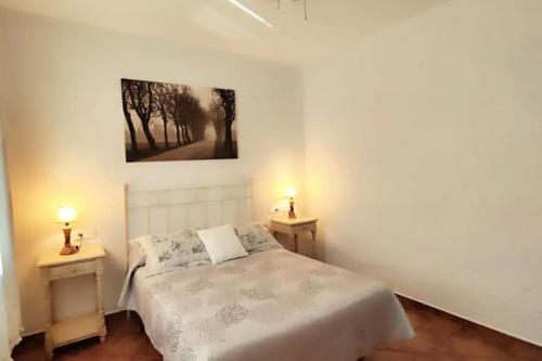 a bedroom with a bed and two night stands at Casa La Roca in El Gastor
