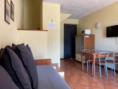 a room with a bed and a table and chairs at Bran & Denise Residence in Costermano sul Garda