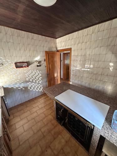 a kitchen with a white counter top in a room at Casa Lugar de Fidalgo in Vilamor