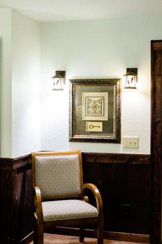a chair in a room with a picture on the wall at Sylvan Valley Lodge and Cellars in Sautee Nacoochee