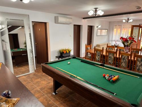 a living room with a pool table and a room with at Casa Maria in Streiu