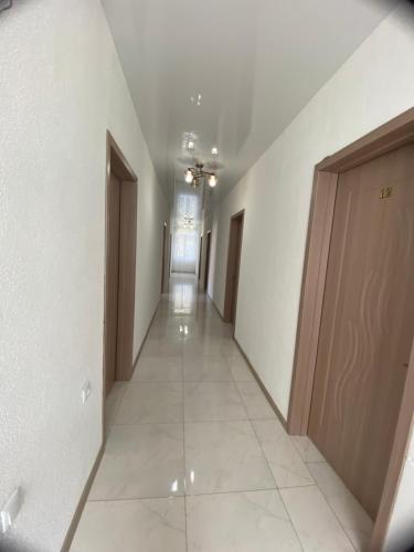 a hallway with white walls and a long corridor at Black Sea Pearl in Makhinjauri