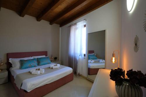 a bedroom with two beds and a large window at Corvina By Zeni in Costermano sul Garda