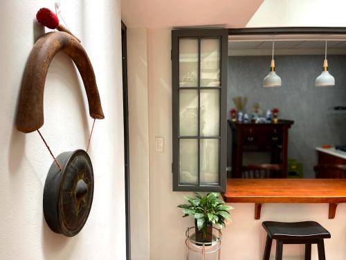 a horseshoe hanging on a wall next to a door at Peaceful house in Hanoi