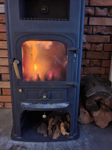 a blue stove with a fire inside of it at 4bedrooms house sleeps14 Garden&Parking Ably Stays in London