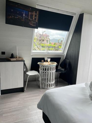 a bedroom with a bed and a large window at Xanelas Do Monte in Petelos