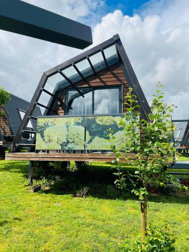 a house sitting on a bench in the grass at Xanelas Do Monte in Petelos