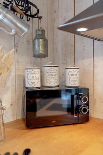a microwave with three candles on top of it at Charmant gîte cosy et romantique à Sanguinet in Sanguinet