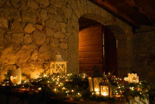 a room with a stone wall with christmas lights at Affittacamere Valnascosta in Faedis
