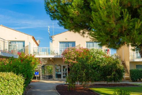 a view of the front of a building at Résidence Goélia Les Jardins De Phoebus in Gruissan