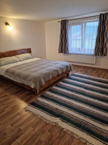 a bedroom with a bed and a large rug at Bucovina-MountainHouse-5BR-Fireplace-HotTub-WiFi in Suceviţa