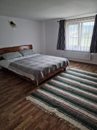 a bedroom with a bed and a large rug at Bucovina-MountainHouse-5BR-Fireplace-HotTub-WiFi in Suceviţa