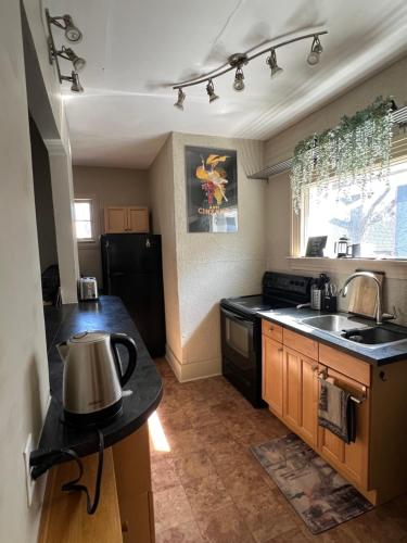 a kitchen with a tea kettle on a counter at Cozy homestay in the master bedroom of a River Heights home in Winnipeg