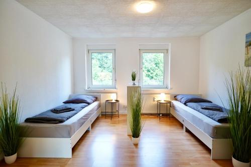 En eller flere senge i et værelse på Wohnung mit 8 Schlafplätzen