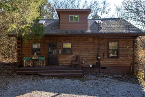 a log cabin with a porch and a table at Its a Cabin Life 4 bed 2 bath in Franklin