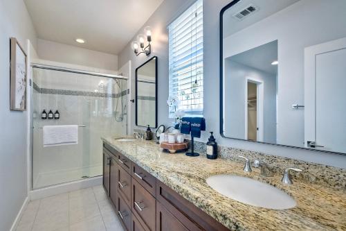 a bathroom with a sink and a shower at Blocks To Beach - Coastal Beach Decor - Garage Parking - Gated Community - 30 Day Fully Furnished in Oceanside