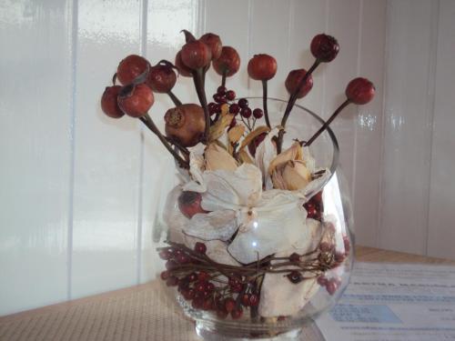 a glass vase with flowers in it on a table at Apartment Maruška in Tolmin