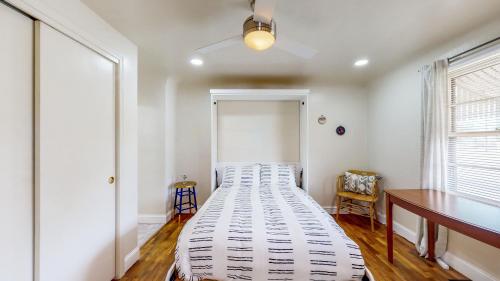 a large bed in a room with a desk and a window at Charming Downtown Bungalow - King Bed, Office in Twin Falls