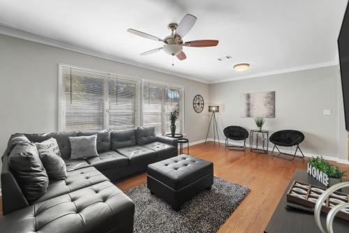 a living room with a couch and a ceiling fan at Elegant 4BDR Atlanta Home Perfect for Families in Stone Mountain