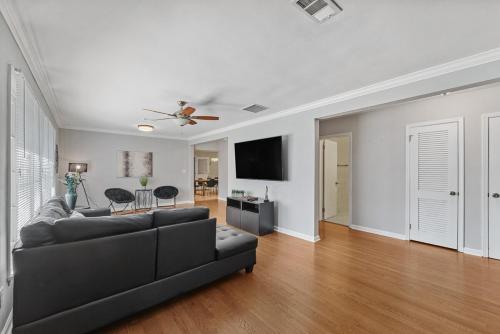 a living room with a couch and a flat screen tv at Elegant 4BDR Atlanta Home Perfect for Families in Stone Mountain