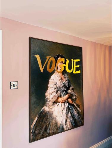 a painting of a woman in a dress on a wall at Penthouse 333a in Middlesbrough
