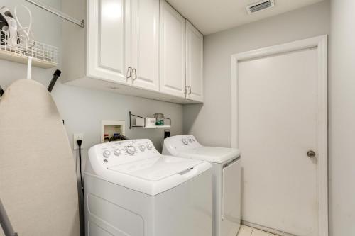 a white laundry room with a washer and dryer at Inviting Jensen Beach Home with Screened-In Patio! in Jensen Beach