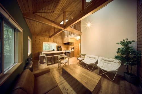 a living room with a couch and a table and chairs at モリテラス凛 -北軽井沢- in Naganohara