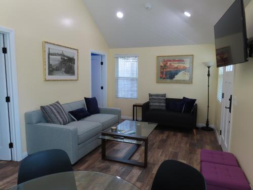 a living room with a couch and a table at Hill Street Cottage in Los Angeles