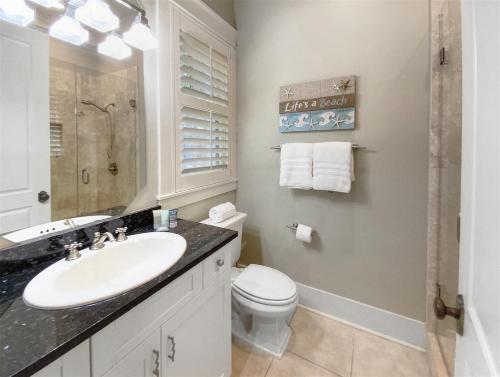 a white bathroom with a sink and a toilet at Inlet Beach - 70 Pinecrest in Panama City Beach
