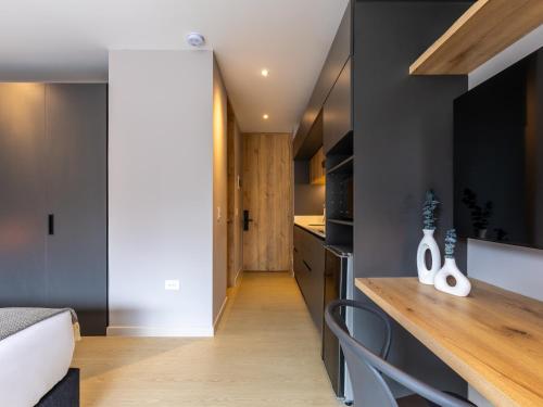 a kitchen with black walls and a wooden counter top at Muttuo by Wynwood House in Bogotá