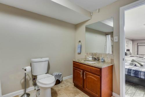 a bathroom with a toilet and a sink and a bed at The Secluded 7-Acre Elegant Escape in Conyers