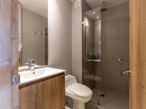 a bathroom with a toilet and a sink and a shower at Muttuo by Wynwood House in Bogotá
