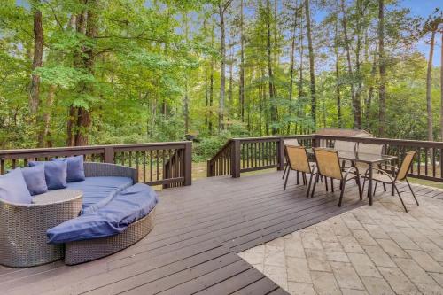 a deck with a couch and a table and chairs at Grand Retreat Sleeps 12 Spacious Deck and WiFi in Fairington