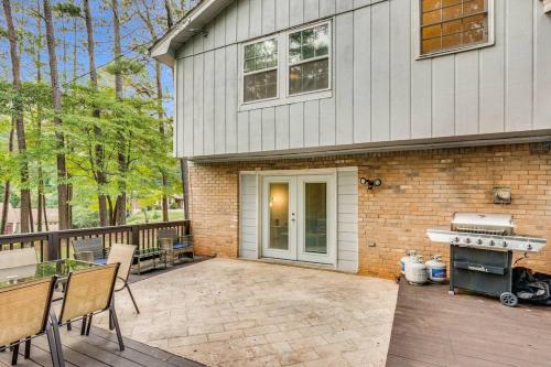 a house with a patio and a grill on a deck at Grand Retreat Sleeps 12 Spacious Deck and WiFi in Fairington