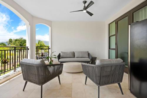 a living room with a couch and chairs on a balcony at Beach & Golf Course Views in Rio Grande