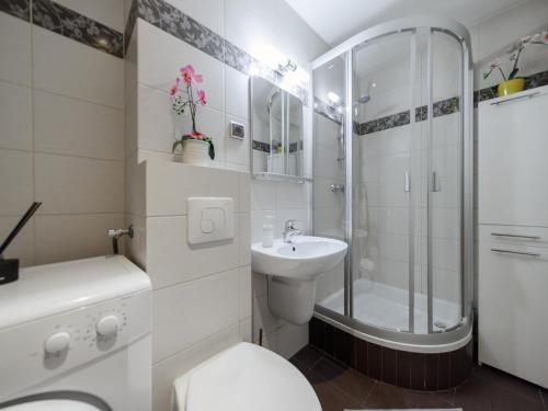 a bathroom with a toilet and a shower and a sink at Luxury apartment Piękna in Warsaw