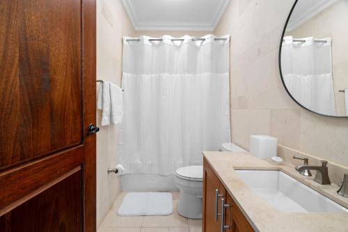 a bathroom with a sink and a toilet and a mirror at Beach & Golf Course Views in Rio Grande