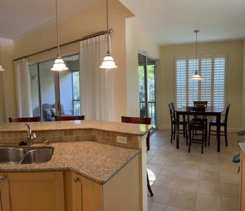 a kitchen and dining room with a table and a dining room at Botanica Condo in Sarasota