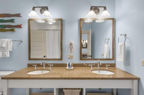 a bathroom with two sinks and two mirrors at Blue Mtn Beach - Red Vill 219 in Santa Rosa Beach