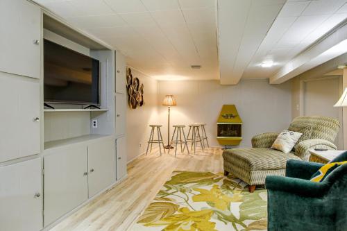 a living room with a couch and a tv at Less Than 1 Mi to Lambeau Field Green Bay Home with Grill! in Green Bay
